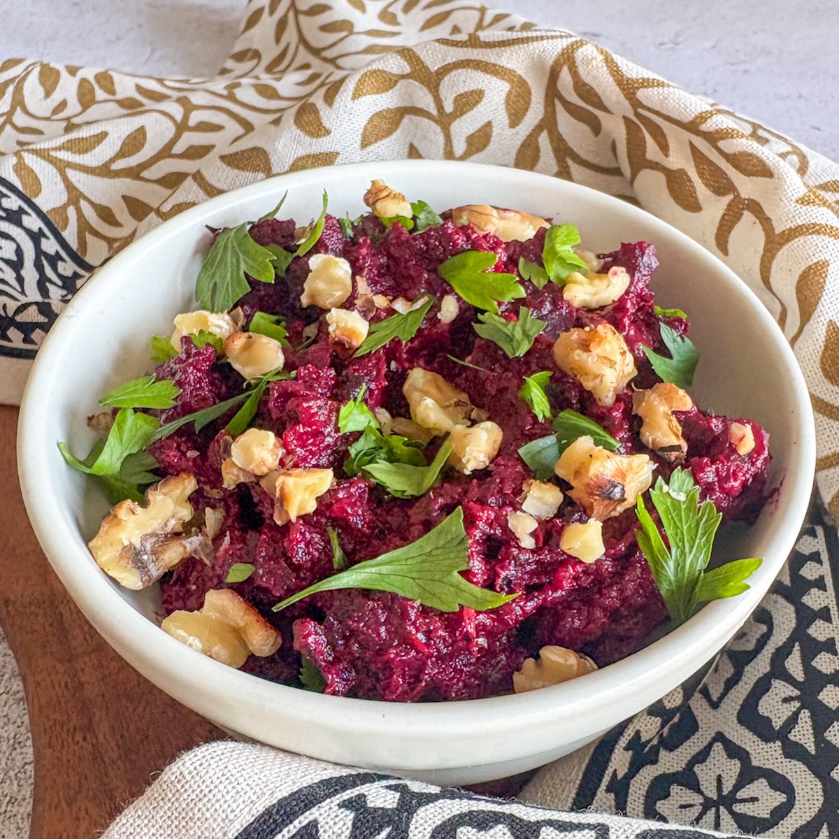 Beetroot and walnut dip with vibrant magenta colour, fresh parsley and toasted walnuts across the top