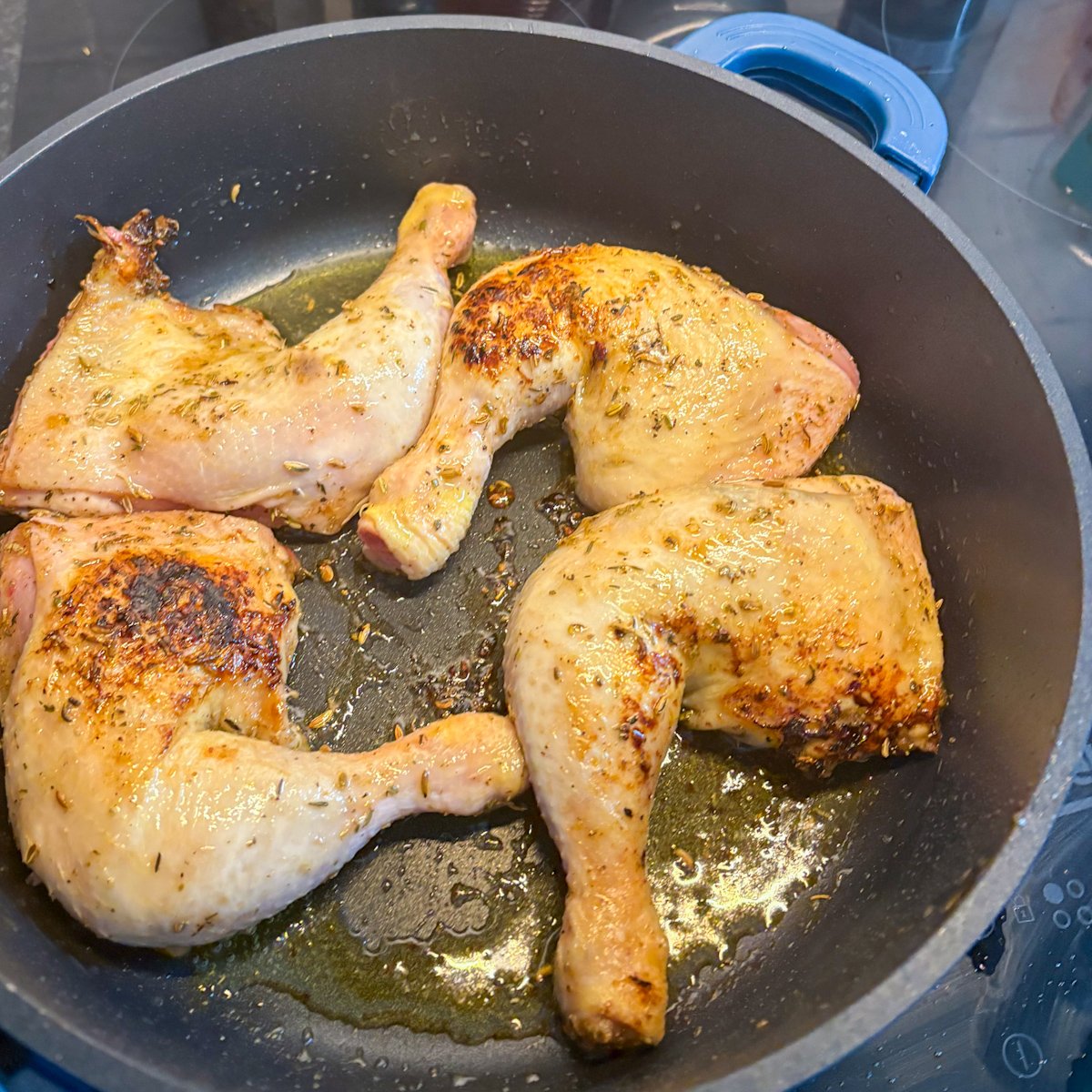 Browned chicken legs frying in a pan for chicken legs with vegetables recipe