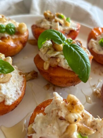 Grilled apricots, soft and caramelised, topped with creamy mascarpone, crunchy walnuts, honey and fresh basil