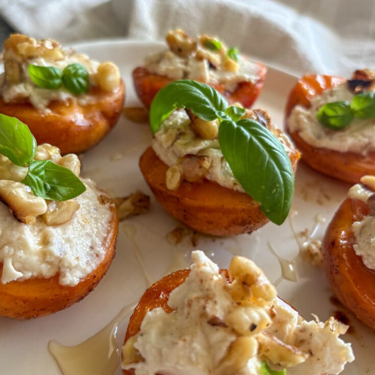 Grilled apricots, soft and caramelised, topped with creamy mascarpone, crunchy walnuts, honey and fresh basil