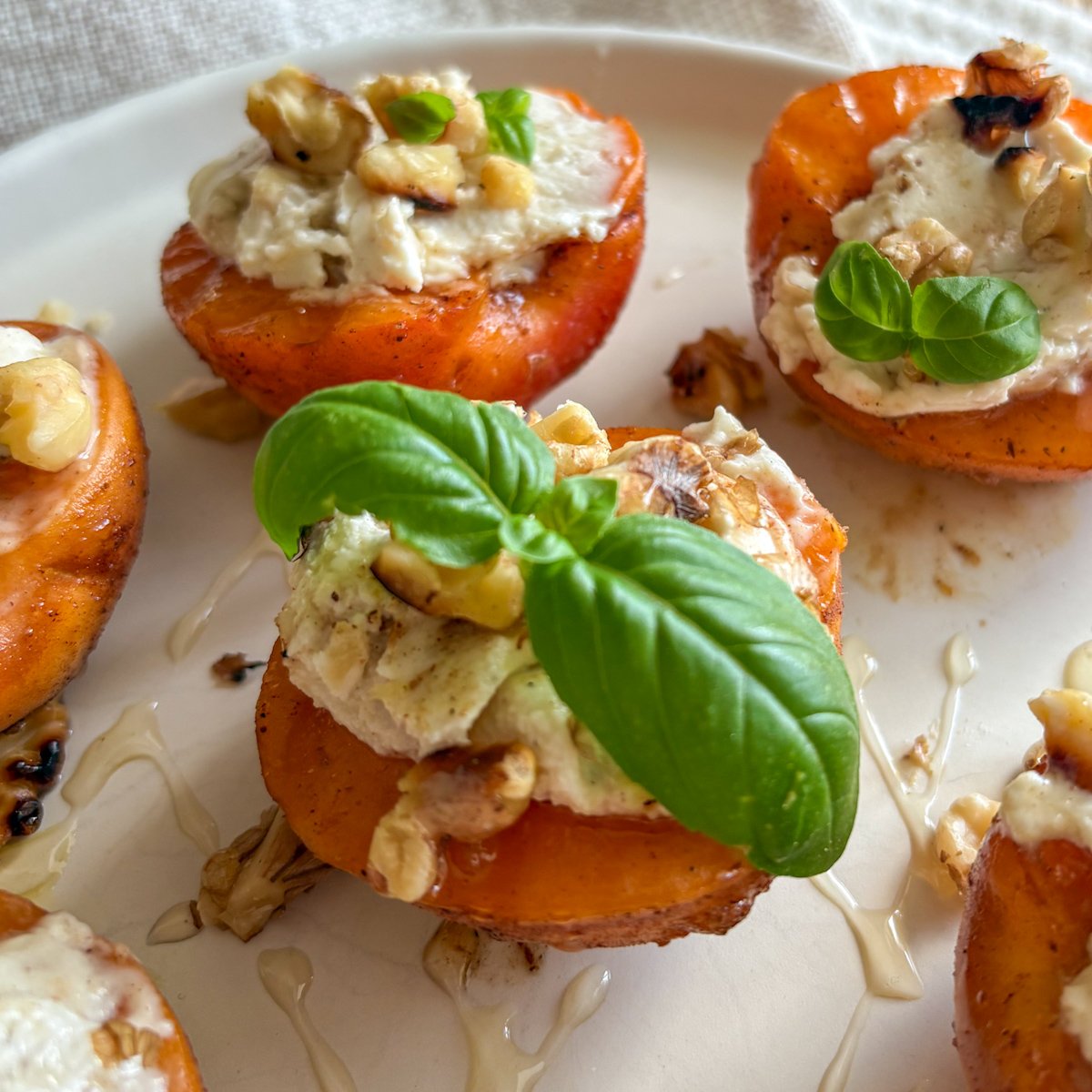 Grilled apricots with silky honey mascarpone, toasted walnuts and basil, glossy with a sweet honey drizzle