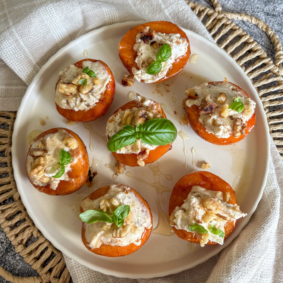Grilled apricots, tender and juicy, dolloped with smooth mascarpone cream, walnuts and fragrant basil leaves