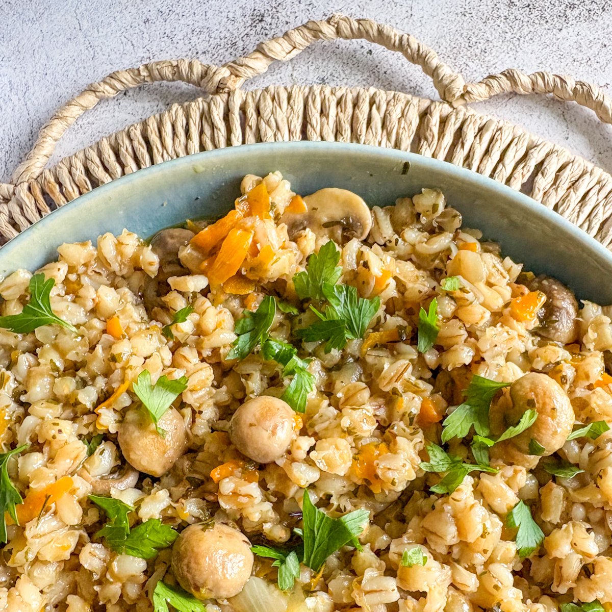Pearl barley with mushrooms and carrots, close-up of chewy golden grains