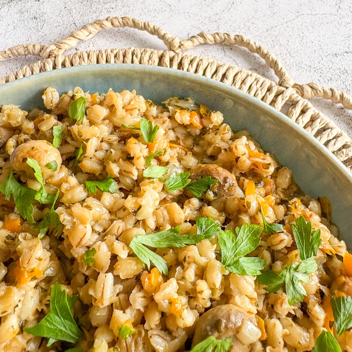 Close-up of tender pearl barley with mushrooms, carrot and parsley