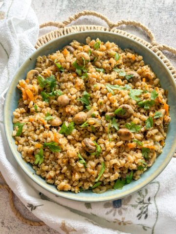 Budget pearl barley with mushrooms garnished with fresh parsley leaves